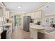 Bright kitchen with white cabinets, stainless steel appliances, and a breakfast bar at 5704 Holiday Park Blvd, North Port, FL 34287