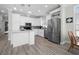 Modern kitchen featuring stainless steel appliances and white cabinets at 9085 Pinehaven Way, Englewood, FL 34224