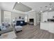 Open living room with gray and blue sofas and a TV at 9085 Pinehaven Way, Englewood, FL 34224