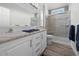 Bathroom with double vanity, shower, and tile flooring at 9085 Pinehaven Way, Englewood, FL 34224