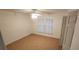 Simple bedroom with ceiling fan, tile floor, and window with curtains at 13528 Martha Ave, Port Charlotte, FL 33981