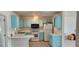 Small kitchen with light blue cabinets and white countertops at 13528 Martha Ave, Port Charlotte, FL 33981