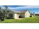 House with green accents, brown roof, and a grassy yard at 13528 Martha Ave, Port Charlotte, FL 33981