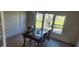 Charming dining area with glass-top table and four chairs near windows at 13528 Martha Ave, Port Charlotte, FL 33981