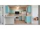 Small kitchen with light blue cabinets and white countertops at 13528 Martha Ave, Port Charlotte, FL 33981