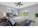 Bedroom with ceiling fan and window, staged with bed at 116 Venice Rd, Rotonda West, FL 33947