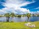 Serene waterfront view with benches and palm trees at 6455 Coniston St, Port Charlotte, FL 33981