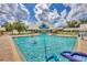 Community pool with residents enjoying the water at 19385 Water Oak Dr # L-106, Port Charlotte, FL 33948