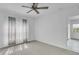 Bright bedroom featuring neutral walls, ceiling fan and window coverings at 19385 Water Oak Dr # L-106, Port Charlotte, FL 33948