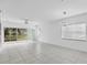 Spacious living room with tile floors and sliding glass doors at 19385 Water Oak Dr # L-106, Port Charlotte, FL 33948