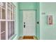 Light teal condo building exterior with white door and window at 19385 Water Oak Dr # L-106, Port Charlotte, FL 33948