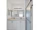 Bathroom with double vanity, large mirror and shower at 19385 Water Oak Dr # L-106, Port Charlotte, FL 33948