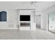 Living room features a built-in entertainment center with fireplace and sliding glass doors at 19385 Water Oak Dr # L-106, Port Charlotte, FL 33948