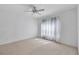 Spacious carpeted bedroom with ceiling fan and window coverings at 19385 Water Oak Dr # L-106, Port Charlotte, FL 33948