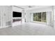 Living room with built-in entertainment center, fireplace, and access to patio at 19385 Water Oak Dr # L-106, Port Charlotte, FL 33948