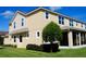 Tan two-story house with screened porch, landscaping, and a grassy yard at 5043 Sunnyside Ln, Bradenton, FL 34211