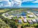 Aerial view of a single-Gathering home with a pool, located in a quiet residential community at 11044 Hogan Cir, Englewood, FL 34223