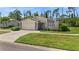 Single-story home with attached garage and well-maintained lawn at 404 Cypress Forest Dr, Englewood, FL 34223