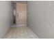 Light beige front door with sidelights and tile flooring at 404 Cypress Forest Dr, Englewood, FL 34223