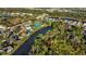 Aerial view of community amenities including a pool, tennis courts, and clubhouse at 404 Cypress Forest Dr, Englewood, FL 34223