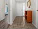 Bright entryway with tile flooring and wooden storage shelf at 404 Cypress Forest Dr, Englewood, FL 34223