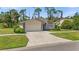 Single-story house with a two-car garage and a neat front yard at 404 Cypress Forest Dr, Englewood, FL 34223