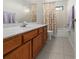 Bathroom with wood cabinets and a shower/tub combo at 404 Cypress Forest Dr, Englewood, FL 34223