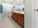 Clean bathroom with wood cabinets and a shower/tub combo at 404 Cypress Forest Dr, Englewood, FL 34223