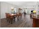 Open dining area with hardwood floors, and a view into the living room at 404 Cypress Forest Dr, Englewood, FL 34223