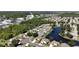 Aerial view of a residential community with a lake and lush landscaping at 404 Cypress Forest Dr, Englewood, FL 34223