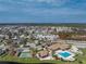 Aerial view of a community with a pool, clubhouse, and shuffleboard at 552 Box Elder Ct, Englewood, FL 34223