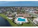Community pool, spa, and clubhouse near a pond at 552 Box Elder Ct, Englewood, FL 34223