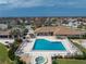 Community pool, spa, and clubhouse with surrounding patio furniture at 552 Box Elder Ct, Englewood, FL 34223