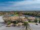 Community clubhouse with pool, tennis courts, and ample parking at 552 Box Elder Ct, Englewood, FL 34223
