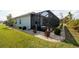 Landscaped backyard with a screened lanai and corner lot views at 552 Box Elder Ct, Englewood, FL 34223