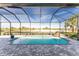 Enjoy this refreshing pool with a waterfall feature and screened enclosure at 14344 Amestoy Ave, Port Charlotte, FL 33981