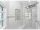 Bright, spacious shower with built-in seat and multiple shower heads at 14344 Amestoy Ave, Port Charlotte, FL 33981