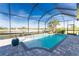 Relaxing screened pool area with a waterfall feature at 14344 Amestoy Ave, Port Charlotte, FL 33981