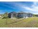 House exterior with fenced backyard and screened patio at 14344 Amestoy Ave, Port Charlotte, FL 33981