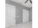 Bedroom with grey walls, white closet doors, and neutral flooring at 14344 Amestoy Ave, Port Charlotte, FL 33981