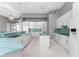 Modern kitchen with white cabinets, granite countertops, and blue glass tile backsplash at 14344 Amestoy Ave, Port Charlotte, FL 33981