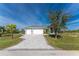 Single-Gathering home with a three-car garage and paved driveway at 14344 Amestoy Ave, Port Charlotte, FL 33981