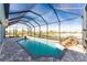 Large screened-in pool with a waterfall and plenty of space for relaxation at 14344 Amestoy Ave, Port Charlotte, FL 33981