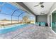 Screened-in pool and patio with ample seating and a tranquil waterfall at 14344 Amestoy Ave, Port Charlotte, FL 33981