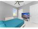 Bedroom with teal bedding, ceiling fan, and large window at 14344 Amestoy Ave, Port Charlotte, FL 33981
