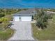 Aerial view of a home with a large driveway at 14344 Amestoy Ave, Port Charlotte, FL 33981