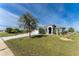 Single-Gathering home with a three-car garage and paved driveway at 14344 Amestoy Ave, Port Charlotte, FL 33981
