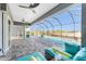 Relaxing pool and patio area with comfortable seating and a view of the backyard at 14344 Amestoy Ave, Port Charlotte, FL 33981