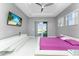 Main bedroom with king bed, access to patio, and large TV at 14344 Amestoy Ave, Port Charlotte, FL 33981