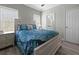 Light and airy bedroom with a queen bed and wood-look floors at 9085 Pinehaven Way, Englewood, FL 34224